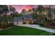Stately home with a three-car garage, elegant architecture, lush lawn, and picturesque landscaping at 138 Great Point Dr, Mooresville, NC 28117