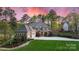 Beautiful home with three-car garage, elegant architectural details, and professionally landscaped yard at 138 Great Point Dr, Mooresville, NC 28117