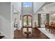 Bright and welcoming foyer with soaring ceiling, ornate front door, and rich hardwood flooring at 138 Great Point Dr, Mooresville, NC 28117
