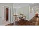 Upstairs hallway showcasing decorative seating, wood floors, trim, and a view of the staircase at 138 Great Point Dr, Mooresville, NC 28117