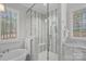 Clean bathroom features a glass enclosed shower, soaking tub, and marble countertops at 138 Great Point Dr, Mooresville, NC 28117