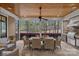 Covered outdoor dining area with ceiling fan, stone floors, and built in outdoor grill at 138 Great Point Dr, Mooresville, NC 28117