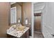 Stylish powder room features unique countertop, decorative mirror, and elevator access at 138 Great Point Dr, Mooresville, NC 28117