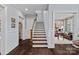 Elegant staircase featuring hardwood steps, white risers, and wainscoting leading to upper levels at 138 Great Point Dr, Mooresville, NC 28117