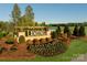 Welcoming entrance to Waxhaw Landing, featuring landscaped grounds, colorful flowers, and a pergola at 1440 Mccollum St, Monroe, NC 28112