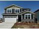 Charming two-story home featuring a two-car garage, stone accents, and a well-maintained lawn at 1440 Mccollum St, Monroe, NC 28112