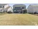 Spacious backyard features a covered patio, expansive lawn, and a privacy fence at 15126 Shallow Ridge Rd, Charlotte, NC 28278