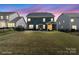 Evening shot of the home's backyard and lawn, with patio and privacy fence visible at 15126 Shallow Ridge Rd, Charlotte, NC 28278