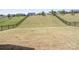 Extensive backyard is enclosed by a black fence and features a gently sloped grassy hill at 15126 Shallow Ridge Rd, Charlotte, NC 28278