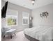 A neutral bedroom with carpet, ceiling fan, natural light, TV, a reading chair, and modern furnishings at 15126 Shallow Ridge Rd, Charlotte, NC 28278