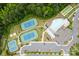 Overhead view of the community center with tennis courts, pool, parking and green spaces surrounded by trees at 15126 Shallow Ridge Rd, Charlotte, NC 28278