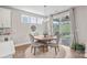 Cozy dining area with a round table, elegant chairs, modern lighting, and sliding door access to the backyard at 15126 Shallow Ridge Rd, Charlotte, NC 28278