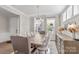 Bright dining room features a modern chandelier, dining table with seating, and a decorative sideboard at 15126 Shallow Ridge Rd, Charlotte, NC 28278