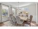 A dining room featuring neutral walls, a wooden table with seating for eight, and large windows at 15126 Shallow Ridge Rd, Charlotte, NC 28278
