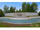 Elegant community entrance fountain featuring The Palisades signage with manicured landscaping and a waterfall at 15126 Shallow Ridge Rd, Charlotte, NC 28278