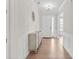 Bright entryway with gleaming wood floors, modern lighting, elegant wainscoting, and decorative wall art at 15126 Shallow Ridge Rd, Charlotte, NC 28278