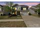 Charming two-story home featuring stone accents, a two-car garage, manicured lawn, and covered porch entry at 15126 Shallow Ridge Rd, Charlotte, NC 28278