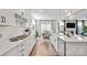 Modern kitchen featuring white cabinetry, subway tile backsplash, stainless steel appliances, and hardwood floors at 15126 Shallow Ridge Rd, Charlotte, NC 28278