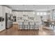 Modern kitchen with white cabinets, stainless appliances, a large island with seating, and hardwood floors at 15126 Shallow Ridge Rd, Charlotte, NC 28278
