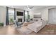 Cozy living room with a fireplace, plush seating, and a large window with bright, natural light at 15126 Shallow Ridge Rd, Charlotte, NC 28278
