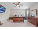 A large bedroom with a ceiling fan, stylish furniture, neutral carpet and walls, and lots of natural light at 15126 Shallow Ridge Rd, Charlotte, NC 28278