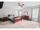 An ample bedroom with neutral walls and carpet, ceiling fan, and large windows providing natural light at 15126 Shallow Ridge Rd, Charlotte, NC 28278