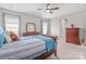 A primary bedroom suite featuring neutral walls and carpet, a large bed, and stylish furnishings at 15126 Shallow Ridge Rd, Charlotte, NC 28278