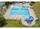 Aerial view of a large community pool with a water slide and lounge chairs for relaxing and summer fun at 15126 Shallow Ridge Rd, Charlotte, NC 28278