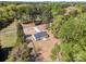 An aerial view shows the house with long driveway, a concrete patio and surrounding nature at 157 Fraley Rd, Gastonia, NC 28052
