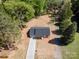 Aerial view of a modern home with an extra long driveway surrounded by lush greenery and mature trees at 157 Fraley Rd, Gastonia, NC 28052