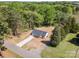 Aerial view of a modern home with an extra long driveway surrounded by lush greenery and mature trees at 157 Fraley Rd, Gastonia, NC 28052