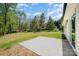 Spacious backyard with concrete patio, ideal for outdoor seating and entertaining in a peaceful, treed setting at 157 Fraley Rd, Gastonia, NC 28052