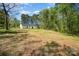A wide shot of the home's backyard and wooded tree line surrounding at 157 Fraley Rd, Gastonia, NC 28052