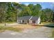 An eye-level view shows the home's side and front, as well as the long driveway leading up to the property at 157 Fraley Rd, Gastonia, NC 28052