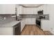 This stunning kitchen boasts granite countertops, stainless steel appliances, and modern backsplash at 157 Fraley Rd, Gastonia, NC 28052