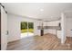 Open concept living room with an open door to a backyard, wood flooring and a kitchen at 157 Fraley Rd, Gastonia, NC 28052