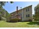 Expansive backyard view, featuring a well-maintained lawn, mature trees, and a charming deck area at 15964 Cumnor Ln, Charlotte, NC 28277