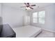 Well-lit bedroom featuring a ceiling fan, two windows, and a neutral color palette at 15964 Cumnor Ln, Charlotte, NC 28277