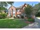 Attractive brick home with a lush green lawn and mature landscaping at 15964 Cumnor Ln, Charlotte, NC 28277