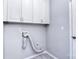 Functional laundry room with upper cabinets and tile flooring at 15964 Cumnor Ln, Charlotte, NC 28277