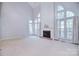 Bright living room features high ceilings, large windows, and a cozy fireplace at 15964 Cumnor Ln, Charlotte, NC 28277