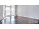 Spacious living room with hardwood floors and large windows for natural light at 15964 Cumnor Ln, Charlotte, NC 28277