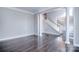 Spacious living room with hardwood floors, columns, and staircase at 15964 Cumnor Ln, Charlotte, NC 28277