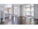 Bright living room featuring hardwood floors, a bay window, and columns at 15964 Cumnor Ln, Charlotte, NC 28277