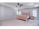 Generous main bedroom with tray ceiling, carpet, and natural light, providing a serene retreat at 15964 Cumnor Ln, Charlotte, NC 28277