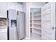 Convenient pantry with organized shelving and a stainless steel refrigerator at 15964 Cumnor Ln, Charlotte, NC 28277