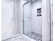 Modern tiled shower with glass door and stone accents, offering a luxurious bathing experience at 15964 Cumnor Ln, Charlotte, NC 28277