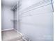 Bright walk-in closet with wall-mounted shelving for optimal storage solutions and organization at 15964 Cumnor Ln, Charlotte, NC 28277