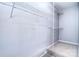 Bright walk-in closet with wall-mounted shelving for optimal storage solutions and organization at 15964 Cumnor Ln, Charlotte, NC 28277