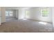 Spacious bedroom with many windows and neutral-colored carpet at 162 Aspire Cir, Wingate, NC 28174